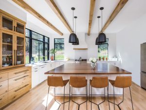 Vinyl Replacement Windows in Boerne kitchen with black trim to contrast the warm wood tones